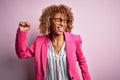 Young african american businesswoman wearing glasses standing over pink background Dancing happy and cheerful, smiling moving Royalty Free Stock Photo