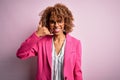 Young african american businesswoman wearing glasses standing over pink background smiling doing phone gesture with hand and Royalty Free Stock Photo