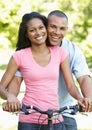 Young African American Couple Cycling In Park Royalty Free Stock Photo