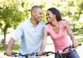 Young African American Couple Cycling In Park Royalty Free Stock Photo