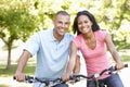 Young African American Couple Cycling In Park Royalty Free Stock Photo