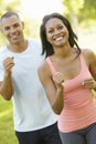 Young African American Couple Jogging In Park Royalty Free Stock Photo