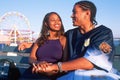 A young African-American couple in love at the Santa Monica Pier, CA Royalty Free Stock Photo
