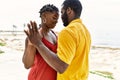 Young african american couple smiling happy dancing at the beach Royalty Free Stock Photo