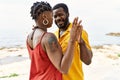 Young african american couple smiling happy dancing at the beach Royalty Free Stock Photo