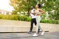 Young African American couple in sportswear running in public park. Jogging healthy concept Royalty Free Stock Photo