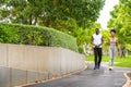 Young African American couple in sportswear running in public park. Jogging healthy concept Royalty Free Stock Photo