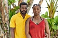 Young african american couple wearing casual clothes standing at the city thinking attitude and sober expression looking self Royalty Free Stock Photo