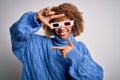 Young african american curly woman wearing 3d glasses over isolated white background smiling making frame with hands and fingers Royalty Free Stock Photo