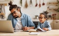 Young african american dad working remotely on laptop with child son at home Royalty Free Stock Photo