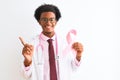 Young african american doctor man holding cancer ribbon over isolated white background very happy pointing with hand and finger to