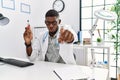 Young african american doctor man holding electronic cigarette at medical clinic pointing with finger to the camera and to you, Royalty Free Stock Photo