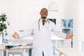 Young african american doctor man looking at the camera smiling with open arms for hug. Cheerful expression embracing Royalty Free Stock Photo