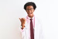 Young african american doctor man wearing pink stethoscope over isolated white background smiling with happy face looking and Royalty Free Stock Photo