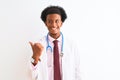 Young african american doctor man wearing sthetoscope over isolated white background smiling with happy face looking and pointing Royalty Free Stock Photo