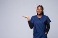 Young african american doctor woman over isolated background open palm, presenting ad smiling happy and confident Royalty Free Stock Photo