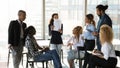 Young african american employee negotiating with colleagues. Royalty Free Stock Photo