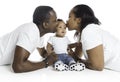 Young African American family in the studio with baby toddler son giving kiss Royalty Free Stock Photo