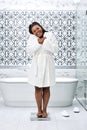 Happy African American Female In Bathrobe Standing On Scales, Checking Weight Royalty Free Stock Photo