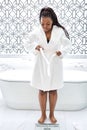 Young African American Female In Bathrobe Standing On Scales, Checking Weight Royalty Free Stock Photo