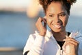 Young African American Female Listening Music In Earphones While Walking Outdoors Royalty Free Stock Photo