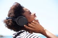 Young african american female listening music on headphone and laughing Royalty Free Stock Photo