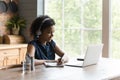 African American woman watch webinar on laptop at home Royalty Free Stock Photo