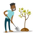Young african-american gardener plants a tree.