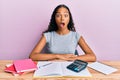 Young african american girl accountant working at the office afraid and shocked with surprise expression, fear and excited face Royalty Free Stock Photo