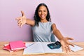 Young african american girl accountant working at the office looking at the camera smiling with open arms for hug Royalty Free Stock Photo