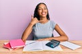 Young african american girl accountant working at the office smiling doing phone gesture with hand and fingers like talking on the Royalty Free Stock Photo