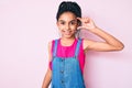 Young african american girl child with braids wearing casual clothes over pink background smiling and confident gesturing with Royalty Free Stock Photo