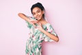 Young african american girl child with braids wearing summer style smiling in love showing heart symbol and shape with hands Royalty Free Stock Photo