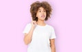 Young african american girl have good idea. Happy smiling afro woman isolated on pink background. Copy space. Template and blank