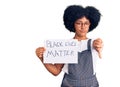 Young african american girl holding black lives matter banner with angry face, negative sign showing dislike with thumbs down,