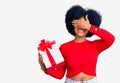 Young african american girl holding gift smiling and laughing with hand on face covering eyes for surprise Royalty Free Stock Photo