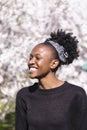 Young african american girl laugs in flowered park Royalty Free Stock Photo