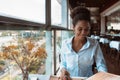 Young African American girl in restaurant with menu