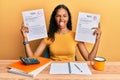 Young african american girl showing failed and passed exam sticking tongue out happy with funny expression Royalty Free Stock Photo