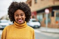 Young african american girl smiling happy standing at the city