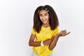 Young african american girl standing over white isolated background with a big smile on face, pointing with hand and finger to the Royalty Free Stock Photo