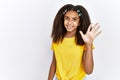 Young african american girl standing over white isolated background showing and pointing up with fingers number five while smiling Royalty Free Stock Photo