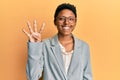 Young african american girl wearing business jacket and glasses showing and pointing up with fingers number four while smiling Royalty Free Stock Photo