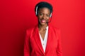 Young african american girl wearing call center agent headset looking positive and happy standing and smiling with a confident Royalty Free Stock Photo