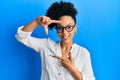 Young african american girl wearing casual clothes and glasses smiling making frame with hands and fingers with happy face Royalty Free Stock Photo