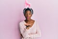 Young african american girl wearing cute easter bunny ears looking at the camera blowing a kiss with hand on air being lovely and Royalty Free Stock Photo