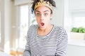 Young african american girl wearing golden queen crown on head afraid and shocked with surprise expression, fear and excited face Royalty Free Stock Photo