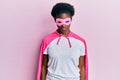 Young african american girl wearing superhero mask and cape costume depressed and worry for distress, crying angry and afraid
