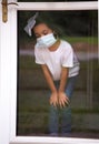 Young African American Girl Wearing a Surgical Mask During a Stay at Home Quarantine