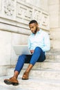 Young African American graduate student with beard studying in N